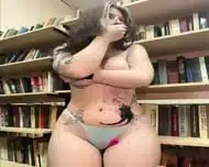A girl completely undresses and masturbates in the public library