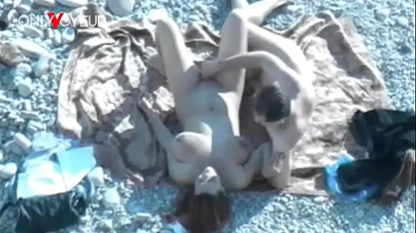 Beach Voyeur. Hot babe with big natural tits gives head on a public beach