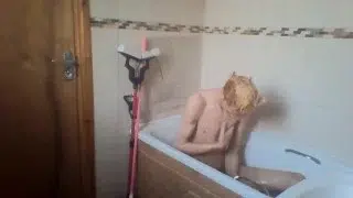 sexy skinny blonde teen takes a bath and wets his hair and cock