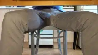 Pissing in jeans under the table